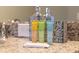 Bathroom set up with clarity shampoo, body wash and conditioner on a gray granite countertop at 2221 Lelani Cir, Davenport, FL 33897