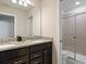 Bathroom with double vanity, granite countertop and a glass enclosed walk-in shower at 2221 Lelani Cir, Davenport, FL 33897