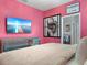 Bedroom featuring bright pink walls, a mirrored dresser, and an en-suite bathroom at 2221 Lelani Cir, Davenport, FL 33897