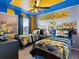 Themed bedroom with colorful decor, twin beds, and fun artwork for a playful atmosphere at 2221 Lelani Cir, Davenport, FL 33897