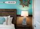 Bedroom detail of nautical decorations, table lamps, and a comfortable bed at 2221 Lelani Cir, Davenport, FL 33897