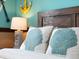Close up of a comfortable bed with decorative, nautical seashell pillows and ocean themed decor at 2221 Lelani Cir, Davenport, FL 33897