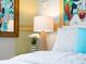 Decorative flower arrangement sits atop a wicker lamp, adding an elegant touch to the bedroom ambiance at 2221 Lelani Cir, Davenport, FL 33897