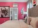 Luxurious bedroom with pink accents, unique decor, and a view towards the en-suite bathroom and pool at 2221 Lelani Cir, Davenport, FL 33897