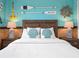 Relaxing bedroom featuring nautical themed decor and a comfortable queen bed at 2221 Lelani Cir, Davenport, FL 33897