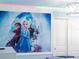 A bedroom wall design featuring 'Frozen' character graphics, soft lighting, and closet at 2221 Lelani Cir, Davenport, FL 33897