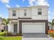 Charming two-story home with stone accents and attached two-car garage at 2221 Lelani Cir, Davenport, FL 33897