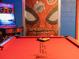 Pool table in a custom-designed Spider-Personal themed game room is ready for a game of billiards at 2221 Lelani Cir, Davenport, FL 33897