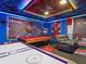Amazing Spider-Personal themed game room featuring air hockey, pool table, and comfortable gray recliner at 2221 Lelani Cir, Davenport, FL 33897
