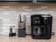 Close up of a Keurig coffee maker and cutlery set on a granite kitchen countertop at 2221 Lelani Cir, Davenport, FL 33897