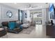 Stylish living room with comfortable seating, neutral tones, and sliding glass doors at 2221 Lelani Cir, Davenport, FL 33897