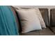 Close up on decorative pillows on a leather sofa with a plush blue blanket for added style at 2221 Lelani Cir, Davenport, FL 33897
