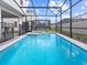 Backyard featuring a sparkling swimming pool, spa, and screened enclosure at 2221 Lelani Cir, Davenport, FL 33897