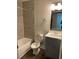 A bathroom with a granite sink and tile shower and tub at 2564 Woodgate Blvd # 102, Orlando, FL 32822