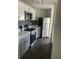Modern kitchen featuring stainless steel appliances, stone countertops and white and gray cabinets at 2564 Woodgate Blvd # 102, Orlando, FL 32822