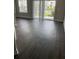 A spacious living room with dark flooring, and sliding glass doors leading to the patio at 2564 Woodgate Blvd # 102, Orlando, FL 32822