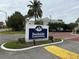 A sign that says Dockside Condominiums with palm trees behind it at 2564 Woodgate Blvd # 102, Orlando, FL 32822