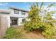 Backyard with mature trees, lawn, and a patio door entrance at 2635 Graduate Ct, Orlando, FL 32826