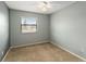 Light-filled bedroom with plush carpeting and a ceiling fan at 2635 Graduate Ct, Orlando, FL 32826