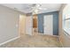 Bedroom featuring a ceiling fan, plush carpeting, and an en-suite bathroom at 2635 Graduate Ct, Orlando, FL 32826