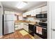 Well-lit kitchen featuring stainless steel appliances, tile flooring, and white cabinetry at 2635 Graduate Ct, Orlando, FL 32826