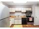 Functional kitchen with appliances, cabinets, and tile flooring at 2635 Graduate Ct, Orlando, FL 32826
