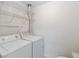 Functional laundry room featuring a washer, dryer, and wire shelving for ample storage at 2635 Graduate Ct, Orlando, FL 32826