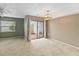 Cozy living room featuring carpet, sliding glass doors to backyard, and ceiling fan at 2635 Graduate Ct, Orlando, FL 32826