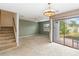 Comfortable living room with carpet, stairs, and sliding glass doors to backyard at 2635 Graduate Ct, Orlando, FL 32826