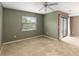 Spacious living room featuring carpet, window, and sliding glass doors to backyard at 2635 Graduate Ct, Orlando, FL 32826