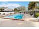 Community pool with lounge chairs, cabana and palm trees at 2635 Graduate Ct, Orlando, FL 32826