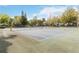 Community tennis court surrounded by mature trees at 2635 Graduate Ct, Orlando, FL 32826