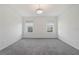 Bright bedroom features neutral walls, gray carpeting, and dual windows for natural light at 2811 Alpine Meadow Ln, Kissimmee, FL 34744