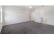 Spacious bedroom with neutral walls, carpet flooring, and doorway to the bathroom at 2811 Alpine Meadow Ln, Kissimmee, FL 34744