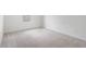 Bright bedroom with neutral carpet, white trim, and a sunlit window at 2811 Alpine Meadow Ln, Kissimmee, FL 34744