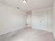 Bright bedroom featuring neutral walls, light carpet flooring, and a double-door closet at 2811 Alpine Meadow Ln, Kissimmee, FL 34744
