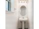 Powder room featuring a pedestal sink, oval mirror, and decorative light at 2811 Alpine Meadow Ln, Kissimmee, FL 34744
