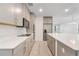 Modern kitchen featuring grey cabinetry, stainless appliances and a center island at 2811 Alpine Meadow Ln, Kissimmee, FL 34744