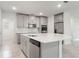 Modern kitchen featuring a large center island with a sink and stainless appliances at 2811 Alpine Meadow Ln, Kissimmee, FL 34744
