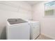 Bright laundry room with a side-by-side washer and dryer and a window at 2811 Alpine Meadow Ln, Kissimmee, FL 34744