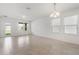 Large living room space filled with natural light and neutral-toned tile flooring at 2811 Alpine Meadow Ln, Kissimmee, FL 34744