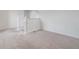 A comfortable loft area with neutral carpet and white banister at 2811 Alpine Meadow Ln, Kissimmee, FL 34744