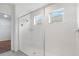 Bright shower features white tile surround and dual windows for natural light at 2811 Alpine Meadow Ln, Kissimmee, FL 34744