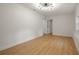 A bright bedroom featuring wood floors and a modern light fixture at 2829 Lake Griffin Rd, Lady Lake, FL 32159