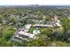 Extensive aerial view of the condo community surrounded by mature trees in a residential neighborhood with a manicured lawn at 3104 Harrison Ave # A6, Orlando, FL 32804