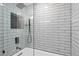 Modern bathroom featuring a sleek, subway-tiled shower with glass door and recessed storage niche at 3104 Harrison Ave # A6, Orlando, FL 32804