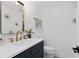Stylish powder room featuring a gold-toned faucet and mirror, a modern vanity, and decorative tile flooring at 3104 Harrison Ave # A6, Orlando, FL 32804