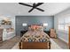 Stylish bedroom with a dark accent wall, ceiling fan, and cozy decor at 3104 Harrison Ave # A6, Orlando, FL 32804