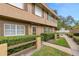 Exterior view of a two-story townhome featuring decorative shutters and a well-maintained lawn at 3104 Harrison Ave # A6, Orlando, FL 32804