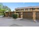 Townhome with brown wooden garages, shutters, and a manicured green hedge at 3104 Harrison Ave # A6, Orlando, FL 32804
